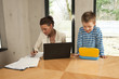 Photo: Young mother working with her son at home Young mother working with her son at home