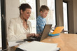 Photo: Young mother working with her son at home Young mother working with her son at home