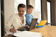 Photo: Young mother working with her son at home Young mother working with her son at home