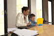 Photo: Young mother working with her son at home Young mother working with her son at home