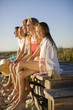 Family sitting on pier near beach