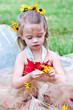 A little woodland fairy gathering flowers.