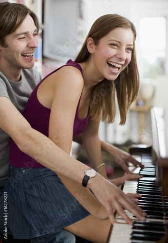 Photo: Couple playing duet on piano Couple playing duet on piano