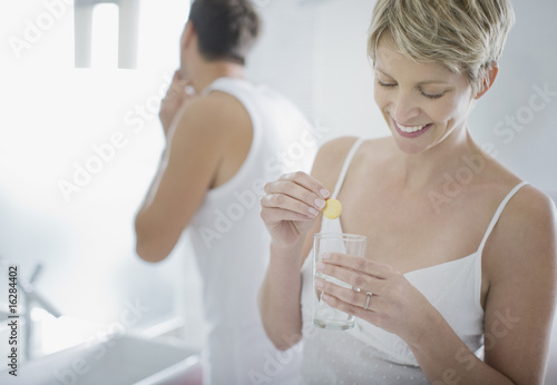 Photo: Woman taking pill in the morning Woman taking pill in the morning