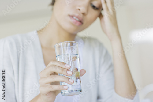 Photo: Woman taking antacid Woman taking antacid