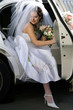 Smiling bride in wedding car limo