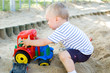 Cute kid playing in sandbox