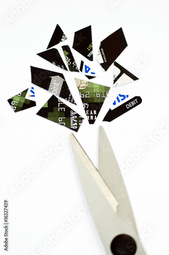 Photo: Scissors cutting up credit card Scissors cutting up credit card