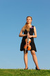 Foto: girl with violin stands on grass against sky girl with violin stands on grass against sky