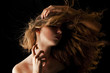 woman with flipping hair applying perfume on her body woman with flipping hair applying perfume on her body