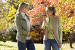 Mother and daughter doing yard work in autumn
