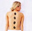 Top view of a woman getting a stone massage therapy