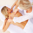 Top view of a young woman pampering herself with a back massage
