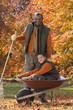 African man and grandson doing yard work in autumn