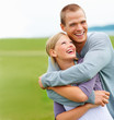 Happy young couple embracing eachother outdoors