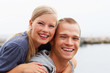 Happy young couple piggybacking outdoors