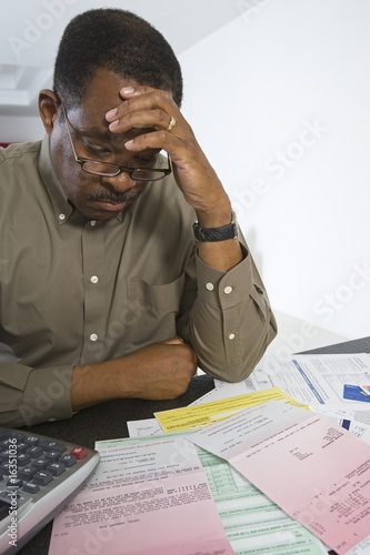 Photo: Senior Man Worrying About Home Finances Senior Man Worrying About Home Finances