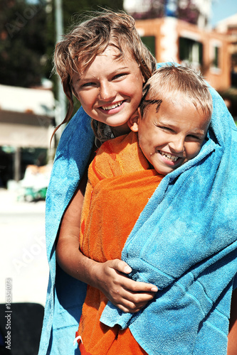 Photo: Portrait of brother and sister having fun on the beach Portrait of brother and sister having fun on the beach
