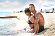 Attractive couple relaxing on the beach