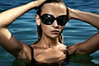 Beautiful young woman at a swimming pool