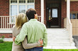 Happy couple in front of home Happy couple in front of home