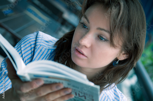 Photo: The fine young girl attentively reads the interesting book The fine young girl attentively reads the interesting book