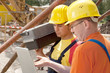 Foto: two workers on a construction site two workers on a construction site