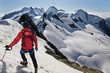 Mountaineer walks down along a snowy ridge Mountaineer walks down along a snowy ridge