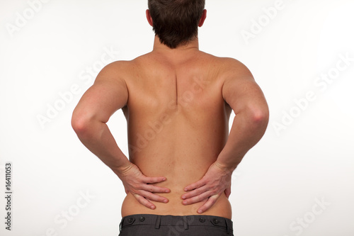 Photo: Man with backpain isolated agasint white Man with backpain isolated agasint white