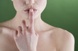 A young woman touching her lips