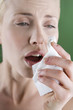 A portrait of a young woman sneezing