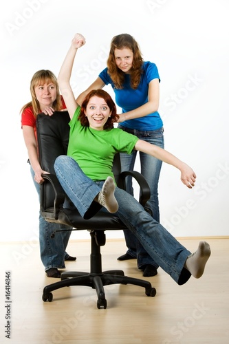 Photo: Women playing on office chair Women playing on office chair