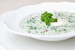 cold soup with choped vegetables and meat on the plate