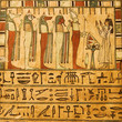 Ancient Egyptian gods and hieroglyphics painted on stone