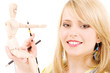 happy teenage girl with wooden model dummy