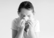Young girl blowing nose
