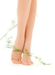 female legs with green plant