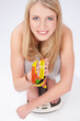 Blond woman with measuring tape on scale