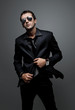 attractive young man wearing elegant black suit and sunglasses attractive young man wearing elegant black suit and sunglasses