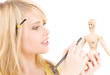 happy teenage girl with wooden model dummy