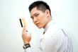 Asian business guy showing gold credit card
