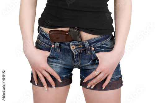 Photo: Young woman with pistol. Isolated on white Young woman with pistol. Isolated on white