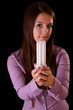 Photo: bright incandescent bulb in young woman hands on black backgroun bright incandescent bulb in young woman hands on black backgroun