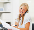 Portrait of a woman speaking on the phone, reading a document