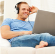 Smart young man listening to music from the internet