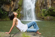 Boy relaxing at waterfall Boy relaxing at waterfall