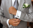 Groom in grey suit ficing his cufflink Groom in grey suit ficing his cufflink