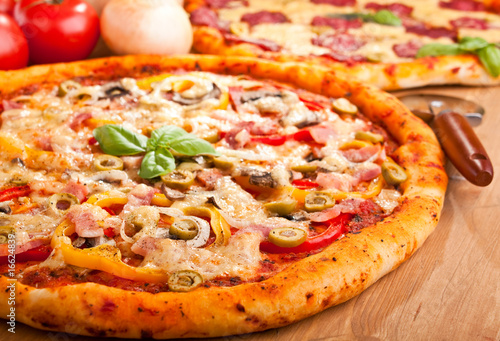 Photo: two pizzas on a table two pizzas on a table