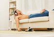 Young guy relaxing on the couch at home hearing music