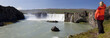 Panorama of Woman Hiker Looking At Godafoss Waterfall, Iceland